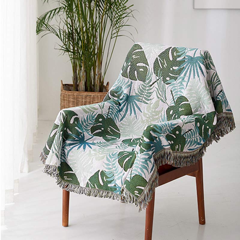 Housse de canapé avec motif palmier et couverture à pompons