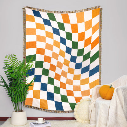 Couverture douce avec motif à damier coloré et pompons
