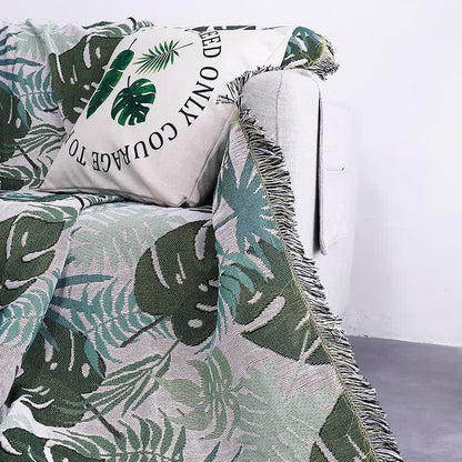 Housse de canapé avec motif palmier et couverture à pompons