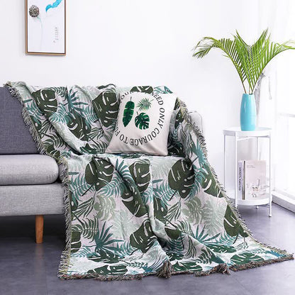 Housse de canapé avec motif palmier et couverture à pompons