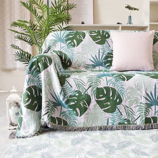 Housse de canapé avec motif palmier et couverture à pompons