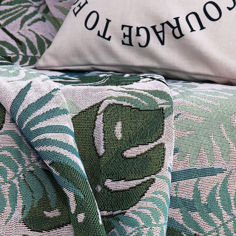 Housse de canapé avec motif palmier et couverture à pompons