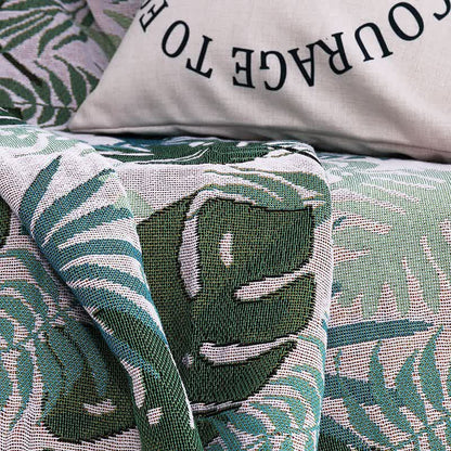 Housse de canapé avec motif palmier et couverture à pompons