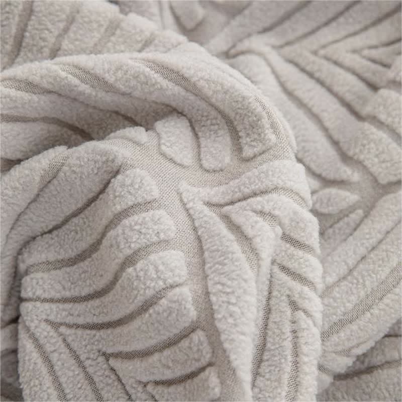 Housse de canapé jacquard unie avec structure en feuilles