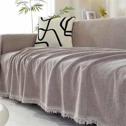 Housse de canapé en chenille avec motif à chevrons et pompons