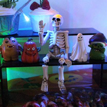 Décoration d'Halloween en résine représentant un squelette avec une main qui fait signe