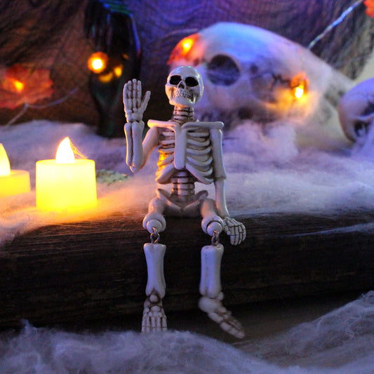 Décoration d'Halloween en résine représentant un squelette avec une main qui fait signe