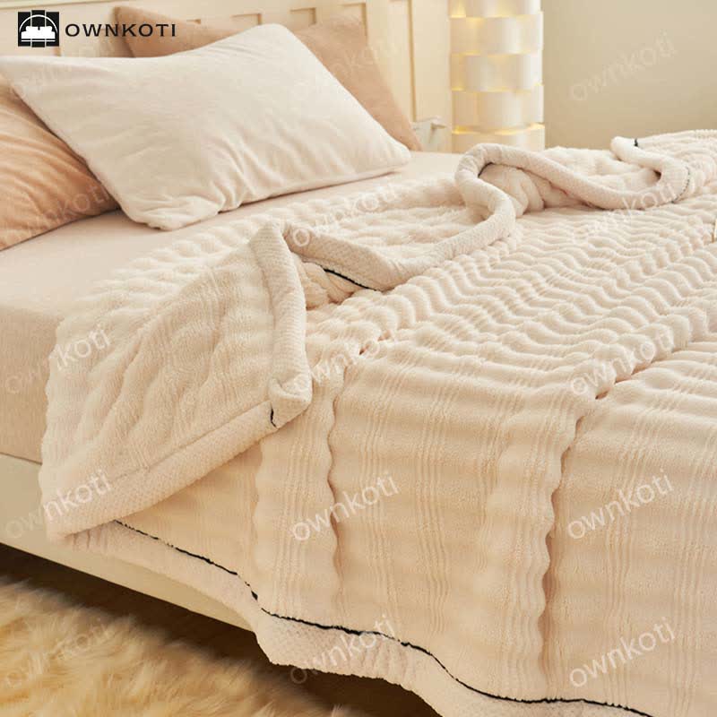 Couverture polaire avec structure ondulée jacquard