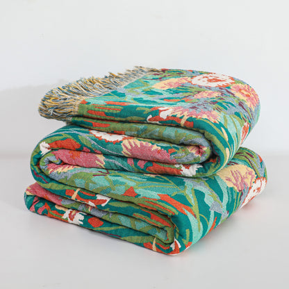 Couverture réversible en gaze de coton à motif floral et pompons