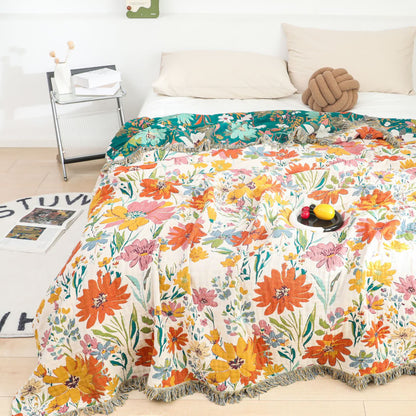 Couverture réversible en gaze de coton avec pompons et motif floral lumineux
