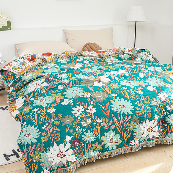 Couverture réversible en gaze de coton avec pompons et motif floral lumineux