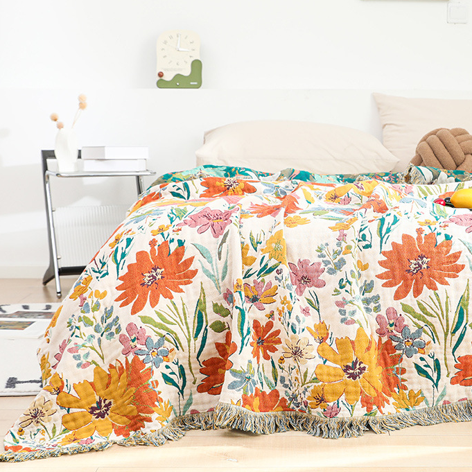 Couverture réversible en gaze de coton avec pompons et motif floral lumineux