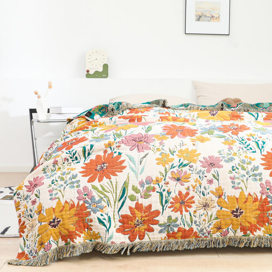 Couette réversible en gaze de coton avec motif floral lumineux et pompons
