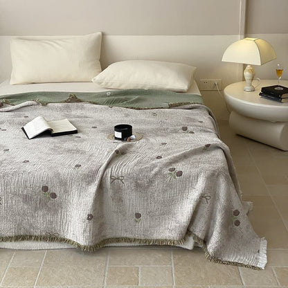Couette réversible en gaze de coton teinte en fil avec pompons
