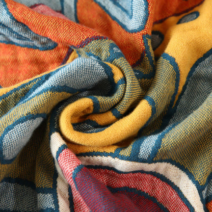 Couverture réversible en gaze de coton avec motif floral artistique et pompons