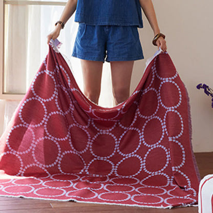 Plaid réversible à motifs circulaires et à pompons - image 4