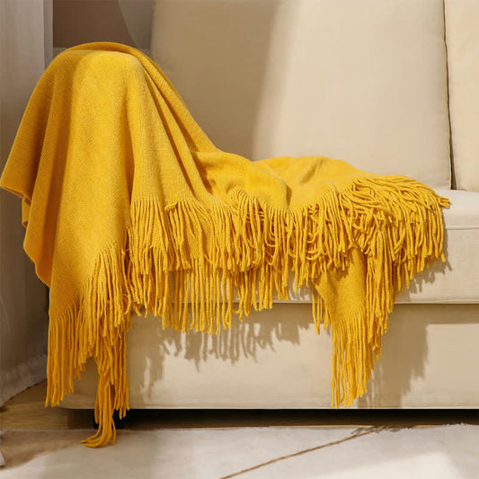 Couverture simple et unie avec des pompons