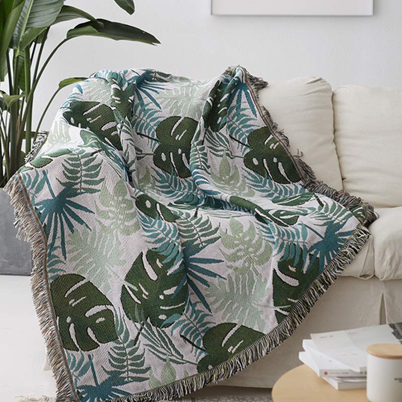 Housse de canapé avec motif palmier et couverture à pompons