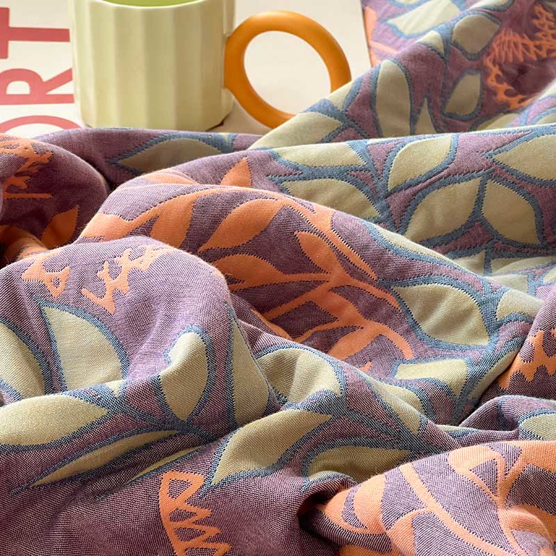 Couette réversible en coton avec des feuilles vertes et oranges