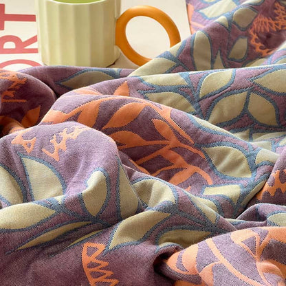 Couette réversible en coton avec des feuilles vertes et oranges