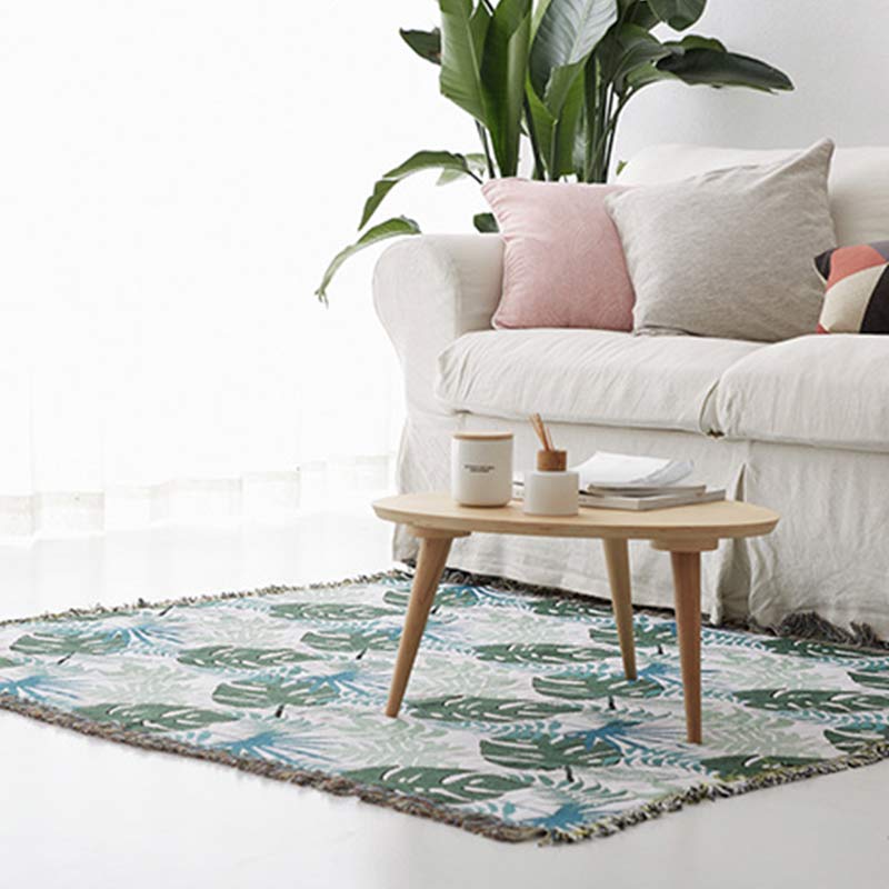 Housse de canapé avec motif palmier et couverture à pompons