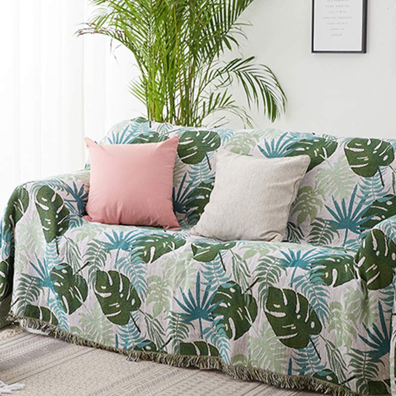 Housse de canapé avec motif palmier et couverture à pompons