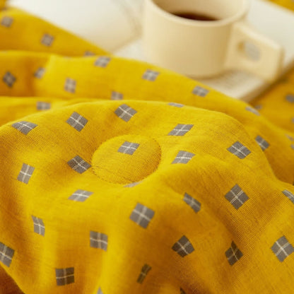 Couverture douce et réversible en pur coton avec un motif quadrillé